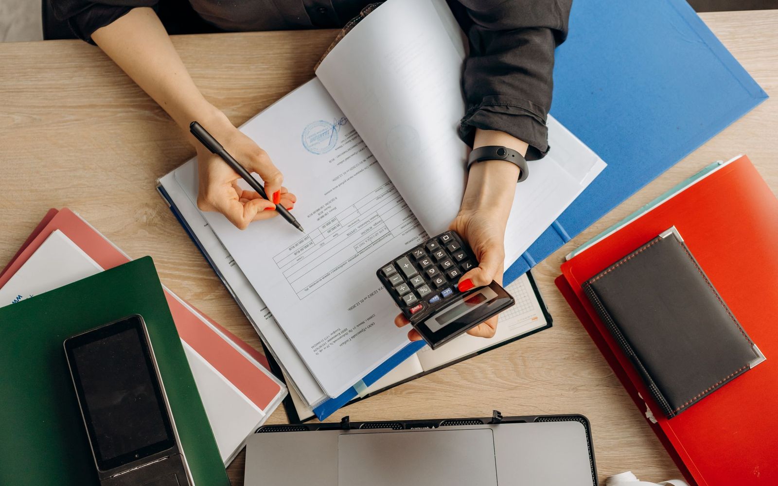 Someone reviewing printed financial paperwork