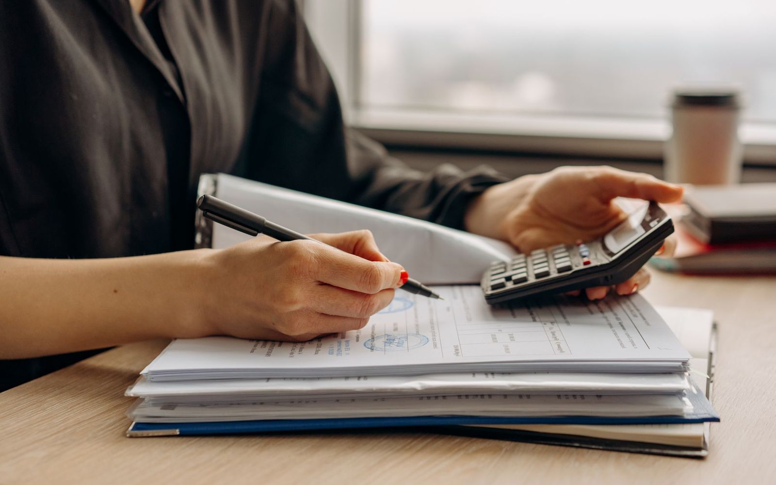 Two people going through paperwork together at a desk