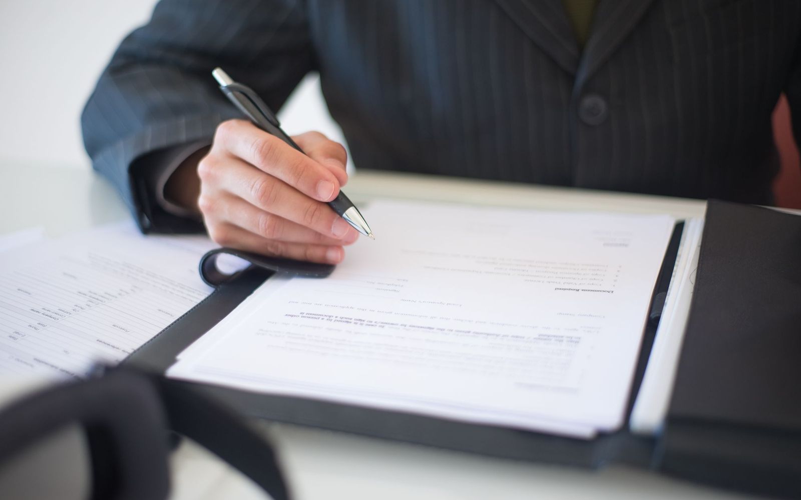 Invoices and paperwork spread across a desk