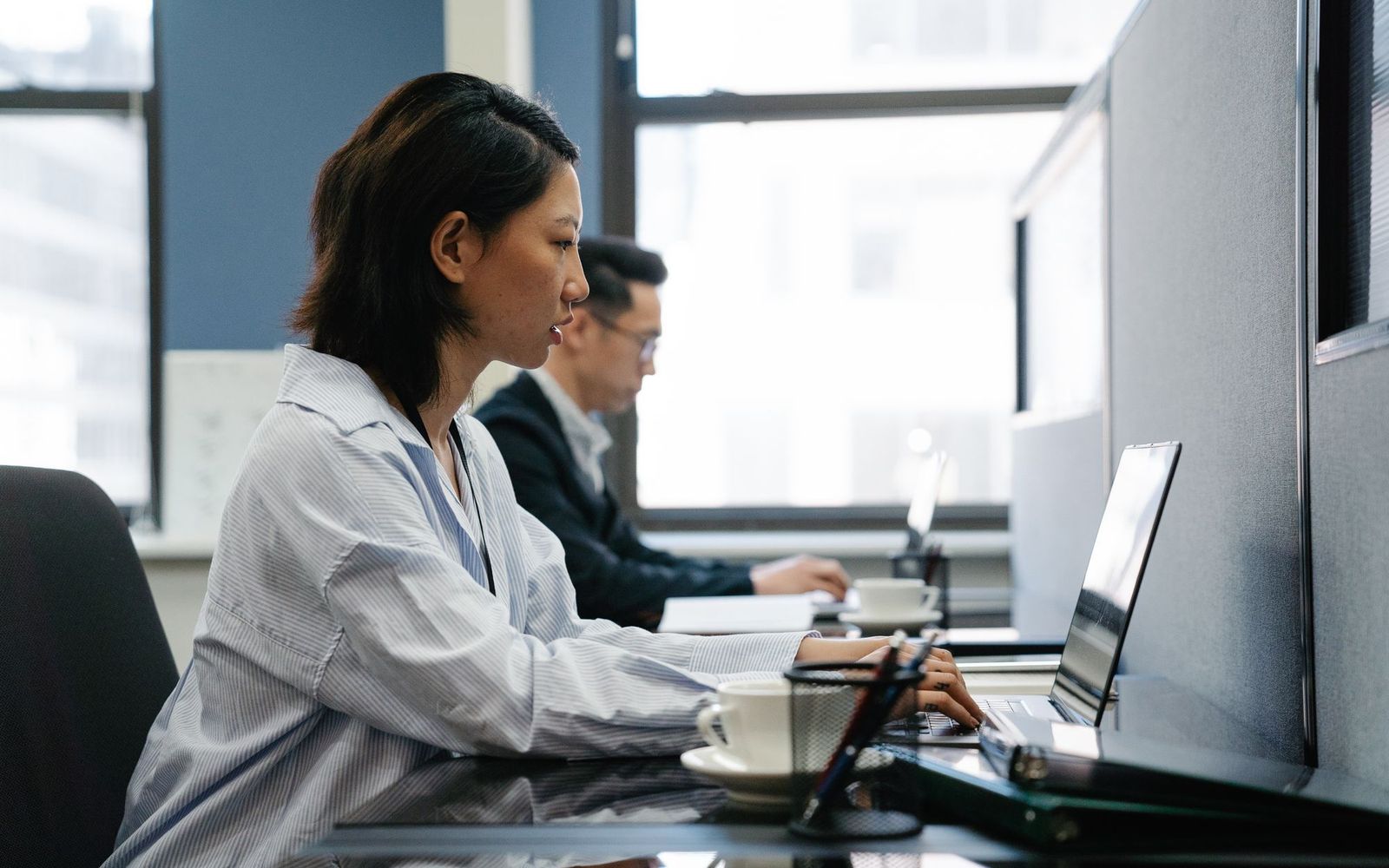 Person working late at a desk with paperwork