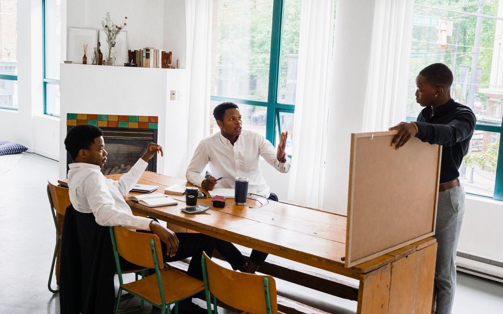 Two people talking across a desk with paperwork