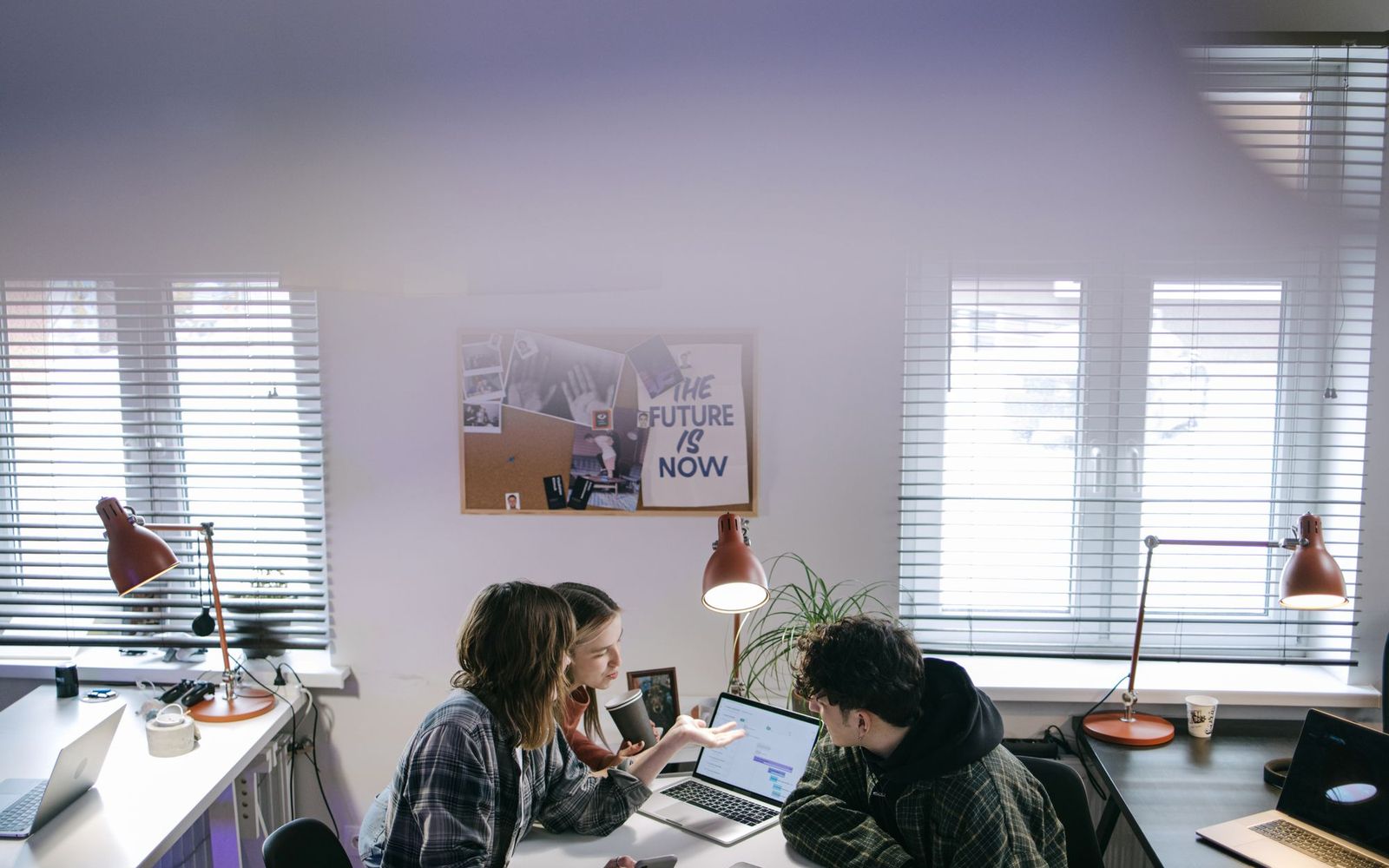 Paperwork and a laptop on a desk