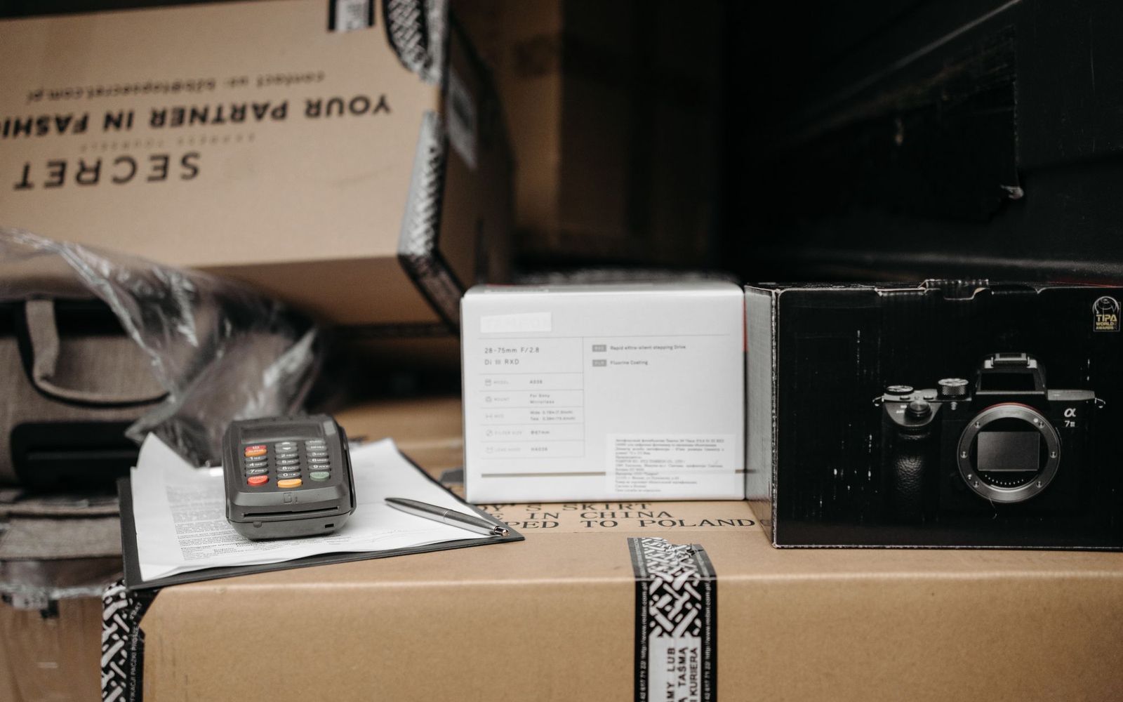 Bills and paperwork spread across a desk with a calculator