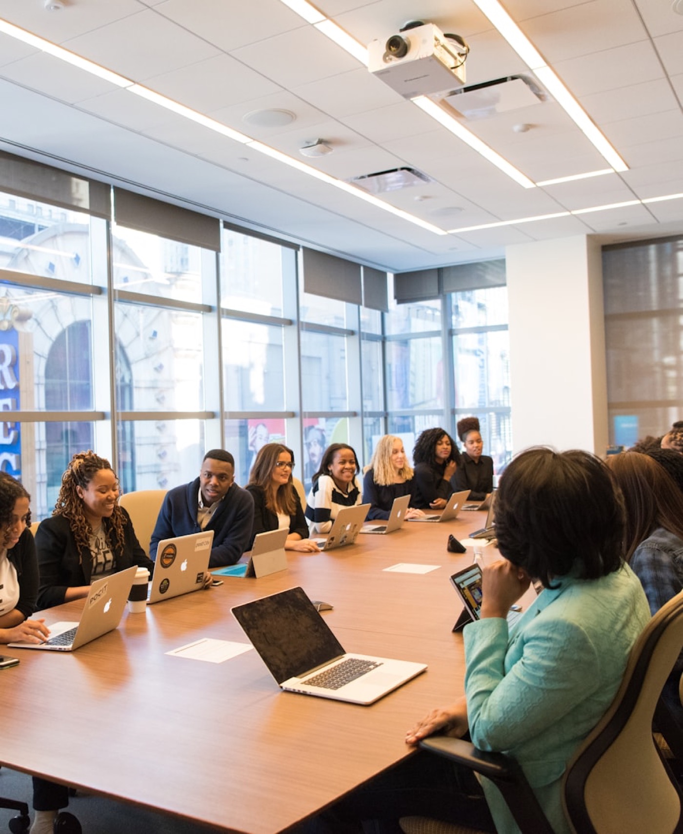 A team meeting around a large boardroom table