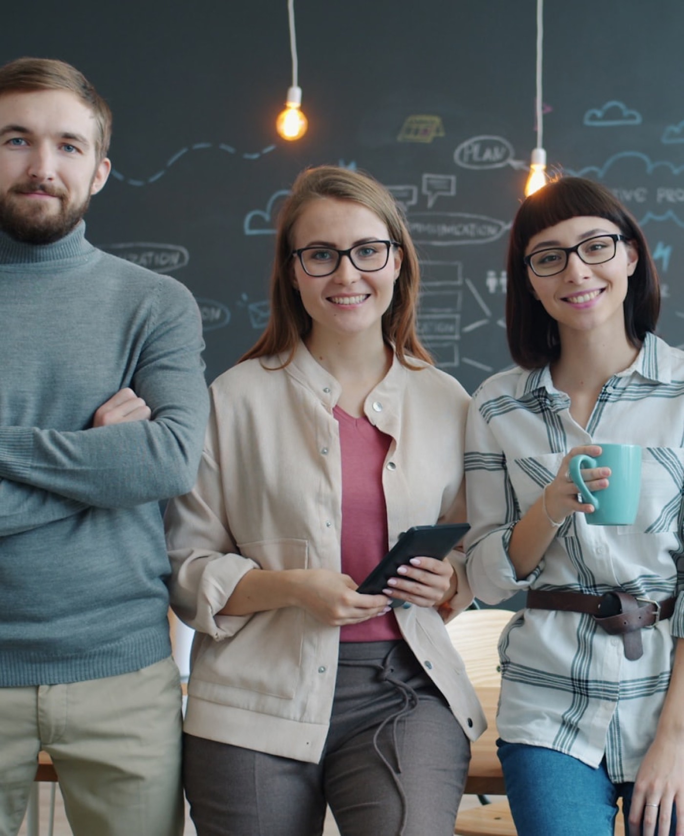 Three founders standing together in a studio office