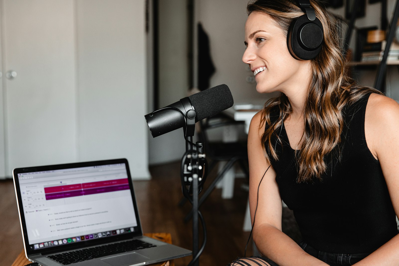A woman sitting in front of a microphone for an interview